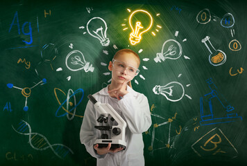 Child holding microscope near chalkboard with science related drawings. Glowing light bulb above girl symbolizing her talent