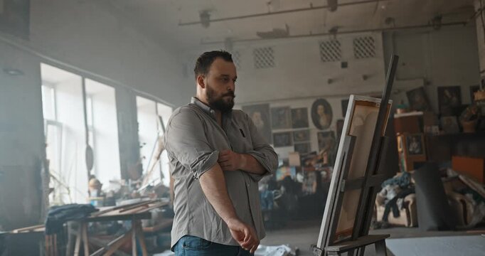 Frustrated artist experiencing creative block in studio