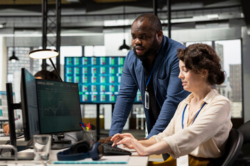 Diverse corporate staff working together on report writing in the office, collaborating on building a new development strategy. Reviewing insights to enhance efficiency and progress.