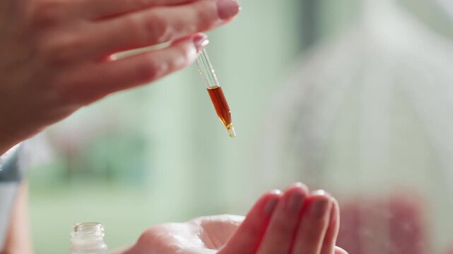 gentle healing process, hands administering herbal medicine delicately, soft touch delivering tincture for recovery, tender hands applying medicinal amber tincture to promote healing and comfort