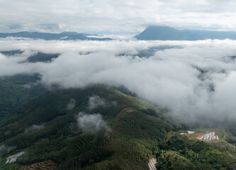 Aerial View of Mountains Above the Clouds with Dramatic Fog Landscape
