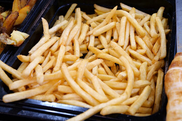 French fries in fast food restaurant. Yellow fried potatoes