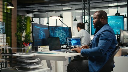 Black man IT expert handles neural networks systems for data forecasting, combining AI automation tools with digitalization to drive multinational company efficiency and innovation.