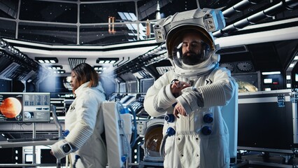 Obraz premium Portrait of joyous astronaut holding helmet performing routine maintenance in starship exploring deep space. Happy cosmonaut navigating orbital trajectory in spacecraft after leaving planet