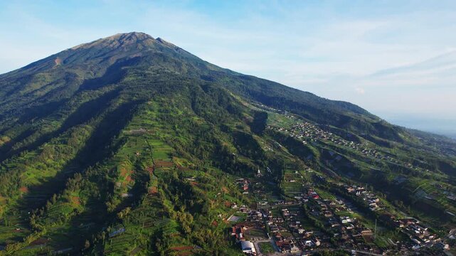 Aerial drone footage of Merbabu volcano, and the surrounding national park, Selo area, villages and gardens, in Indonesia