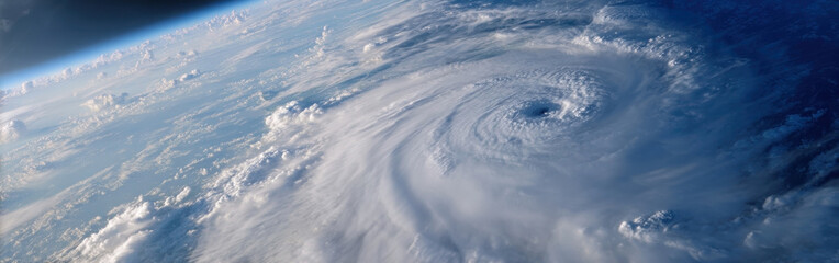 Powerful hurricane spirals over the ocean, revealing a captivating eye and swirling clouds from an aerial view