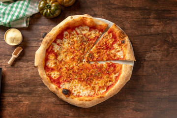 Fresh margherita pizza slice on wooden background