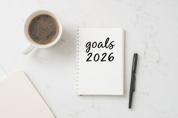 minimalist setup with coffee pen and notebook reading 2026 date