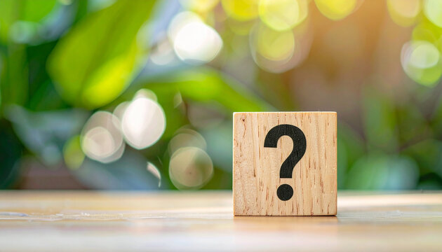 Wooden block with question mark symbol, green plants, FAQ, Q and A, problem solving idea.