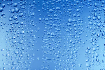 Glass surface with water drops, closeup view