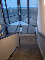 A modern staircase in an office building with panoramic windows