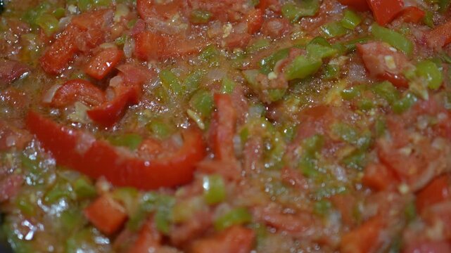 Close-Up of Freshly Made Sofrito for Paella with Tomato, Onion, Red and Green Bell Pepper and Olive Oil, Traditional Spanish Cooking Base
