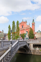 Fototapeta premium Picturesque Triple bridge with the Church in Ljubljana, Slovenia on a sunny day.