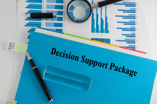 A 'Decision Support Package' document on a desk, accompanied by a process graph, computer keyboard, and office stationery