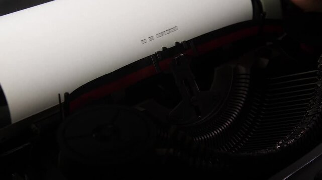 Vintage typewriter impressing words to be continued on white paper, reflecting concepts of storytelling, writing, and creating suspense for a narrative cliffhanger