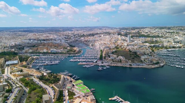 Epic yacht marina aerial reveal. 
Cinematic 4K drone forward 
flight with tilt down over 
luxury sailboats and harbor 
in Msida, Malta.

