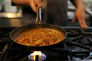 chef preparing gnocchi by hand in the traditional way