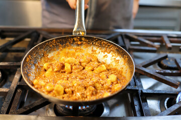 chef preparing gnocchi by hand in the traditional way