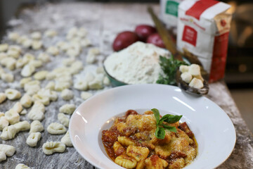 chef preparing gnocchi by hand in the traditional way