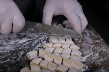 chef preparing gnocchi by hand in the traditional way