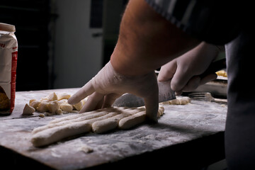 chef preparing gnocchi by hand in the traditional way