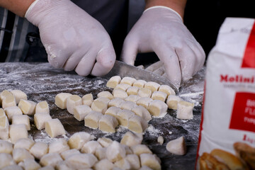 chef preparing gnocchi by hand in the traditional way