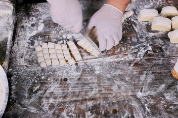 chef preparing gnocchi by hand in the traditional way