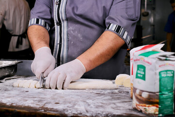 chef preparing gnocchi by hand in the traditional way