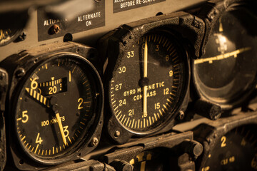 Close-up of vintage aircraft cockpit instruments showing gauges and dials.