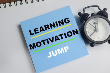 Fototapeta premium Concept of learning, motivation, jump write on sticky notes isolated on Wooden Table.