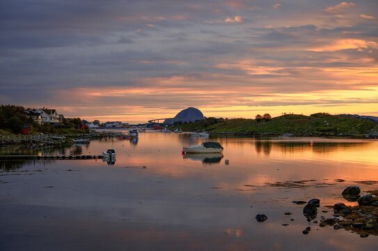 Peaceful coastal harbor at sunset with boats and reflections - Powered by Adobe