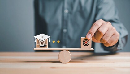 Hand balancing education and achievement on a wooden scale with graduation cap, books, and target for goal setting and future success.
