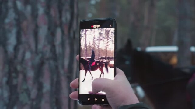 winter horse scene, equestrian in icy snowy winter landscape, vertical frame capturing rider and steed in wintry silence, video depicting rider and horse amidst chilling frozen snowy countryside