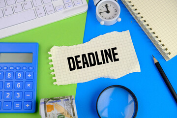 keyboard, alarm clock, bank note and book with the word deadline on blue and green background