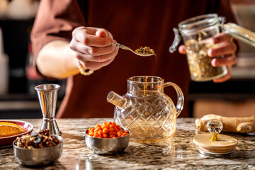 Preparing Herbal Fruit Tea In Glass Teapot