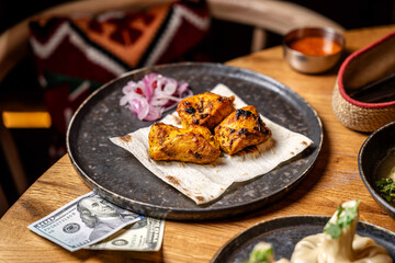 Grilled Chicken Pieces On Flatbread Plate