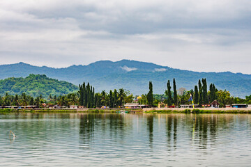 Fototapeta premium Morning atmosphere of Lake Rowo Jombor, Klaten Regency, Indonesia, Lake with a mountain background