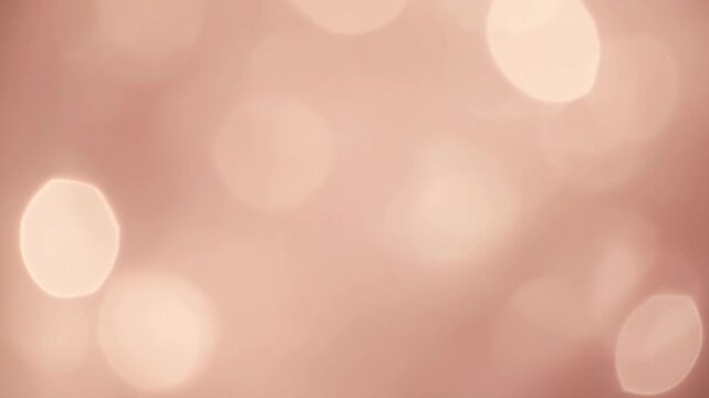 Soft Focus Bokeh Lights on a Warm Rose Gold Background. 4k Footage Video