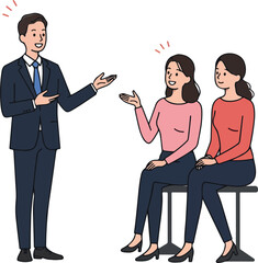Man In Suit Gesturing To Two Women Sitting On Chairs White Background