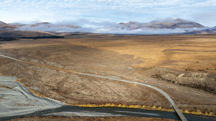Aerial perspective of the countryside around the shore of an alpine Lake Heron in Hakatere conservation area