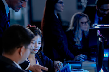 Cyber defenders hold the line late night ops center. Focused diverse analysts track threats multiple screens real time data intelligence crucial vigilance protects vital systems now.