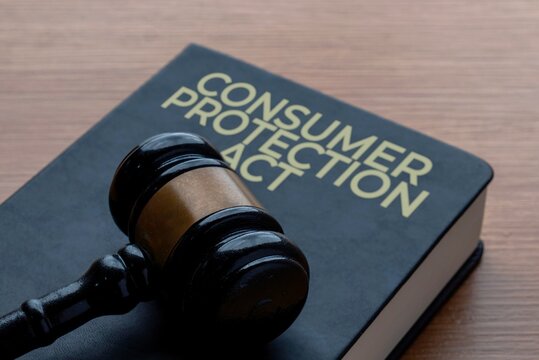 A gavel on a book titled CONSUMER PROTECTION ACT. Legal rights, retail safety, law, justice, and customer defense concept.