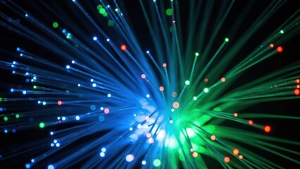 Obraz premium Abstract fiber optic light strands glowing blue, green, and red on a dark background.