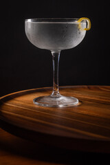 Beautiful gin martini garnished with a lemon twist with dramatic lighting