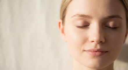 Naklejka premium Calm Woman with Closed Eyes Enjoying Peaceful Moment in Soft Light