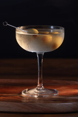 beautiful and dramatic lighting on a dirty martini with 3 olives
