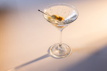 Beautiful and refreshing Martini with two olives with play in the highlights and shadows and color temperatures.