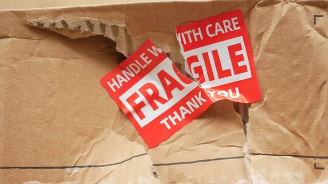  a damaged box with fragile stickers on it.