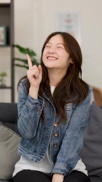 Excited Young Woman Gesturing Idea Indoors on Camera