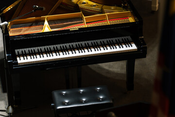 Close-up of a piano captured under dramatic lighting.